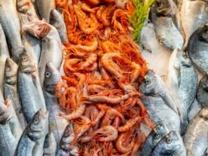 Fresh seafood including fish and prawns at a market
